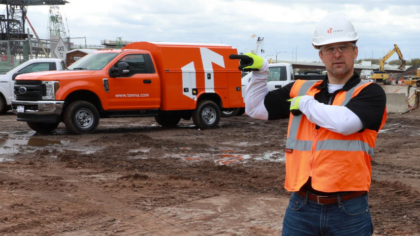 Tenna Field Worker pointing to Tenna Truck to show Competitor Comparison