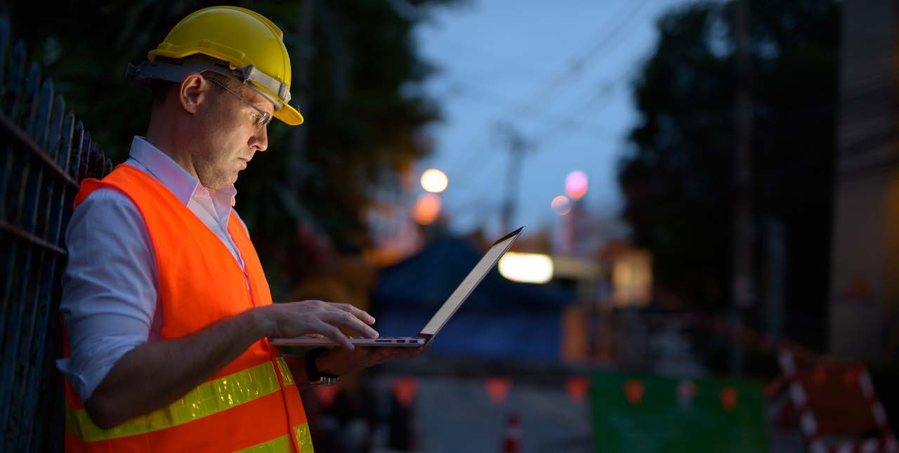 Construction Worker looking at ERP Integrations on Device