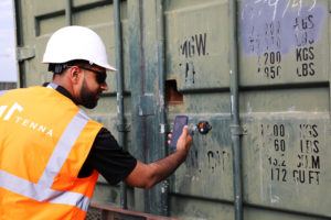 Tenna customer success manager scanning a TennaBLE Beacon on a conex box