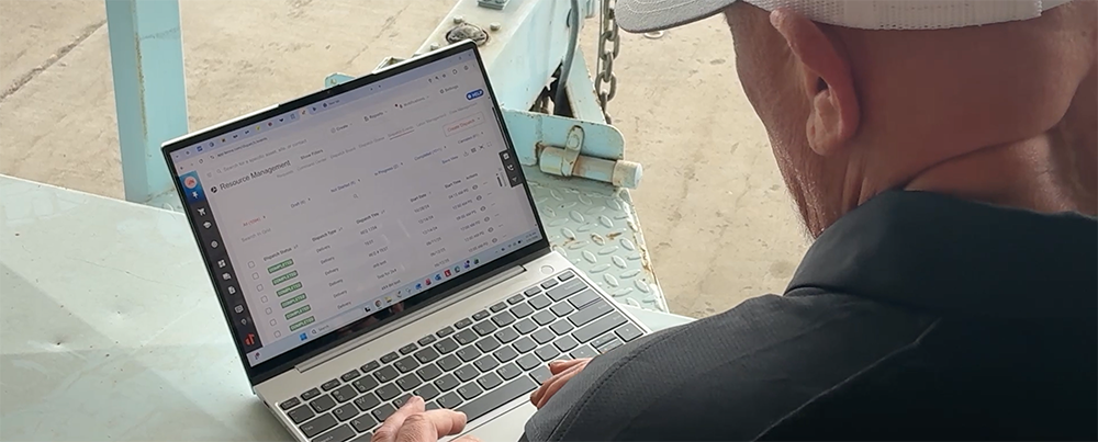 Tenna user looking at the construction dispatch and scheduling software on his laptop.
