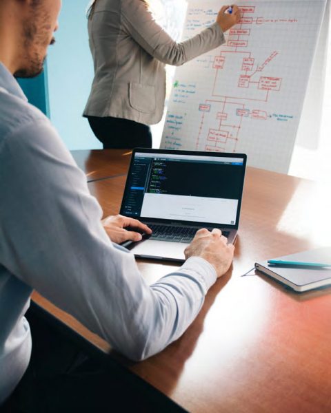 Man looking at Laptop with Equipment Share Tracking Solutions