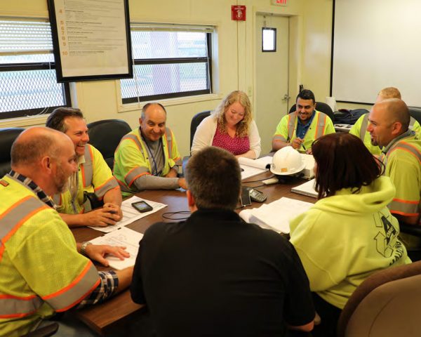 Workers discussing Equipment Share Tracking Solutions