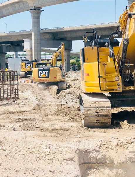 Multiple CAT Equipment Trucks on a D. Guerra Construction site